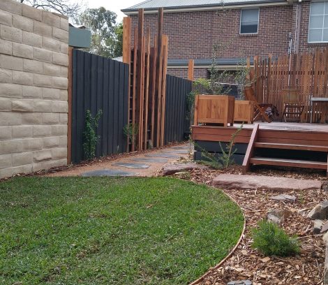 Finished backyard landscaping with the fence panel feature